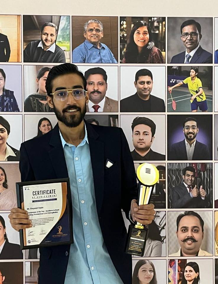 Divyansh holding the Entrepreneur of the Year certificate and trophy at the International Excellence Awards 2026